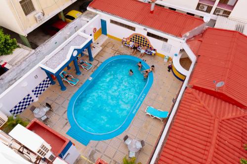 an overhead view of a swimming pool with people in it at Hotel Edmar in Santa Marta