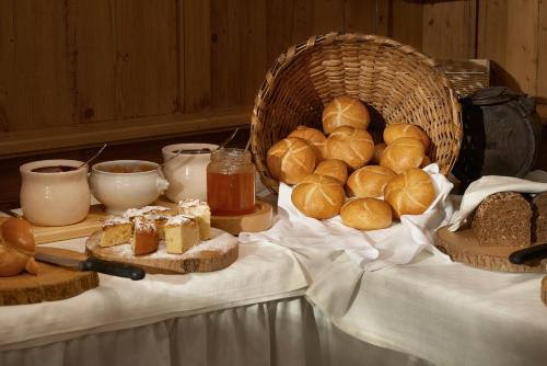 a table topped with bread and baskets of pastries at Posthotel Strengen am Arlberg in Strengen