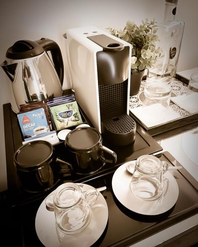 a counter with dishes and a coffee maker on it at The ART INN Lisbon in Lisbon
