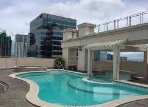 a large blue swimming pool in a building at Rare 1BR condo, Makati Philippines in Manila