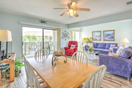 a living room with a table and a couch at Beachside St Augustine Resort Condo, 6 Mi to Dtwn! in Coquina Gables