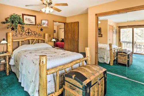 a bedroom with a large bed and a glass door at South Dakota Vacation Rental Near Mount Rushmore in Hermosa