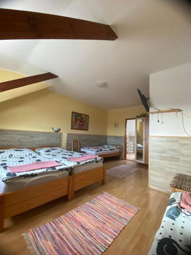 1 dormitorio con 2 camas y alfombra en Gaál Vendégház, en Szentgotthárd