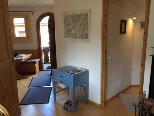 um quarto com uma mesa azul e um corredor em Chesa Linaira em Pontresina
