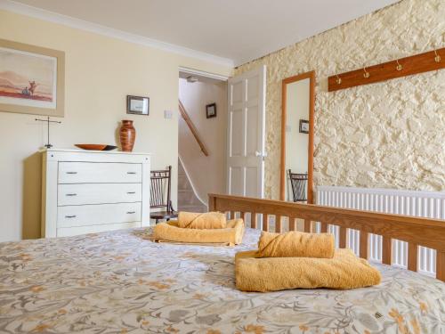 a bedroom with a bed with two pillows on it at 14a Courtenay Street in Salcombe