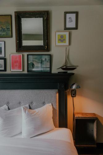 a bedroom with a bed and a mirror on the wall at KEX Hotel in Portland