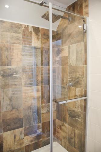 a shower with a glass door in a bathroom at Stara Kuźnia Mazurska in Węgorzewo