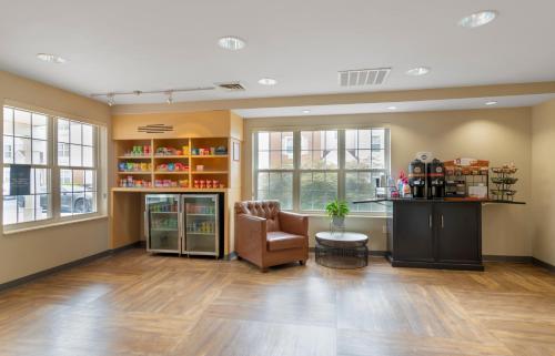 a waiting room with a chair and a table and windows at Extended Stay America Suites - Atlanta - Norcross - Peachtree Corners in Norcross