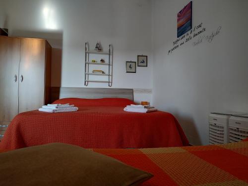 A bed or beds in a room at Camere "Riviera di Ulisse"