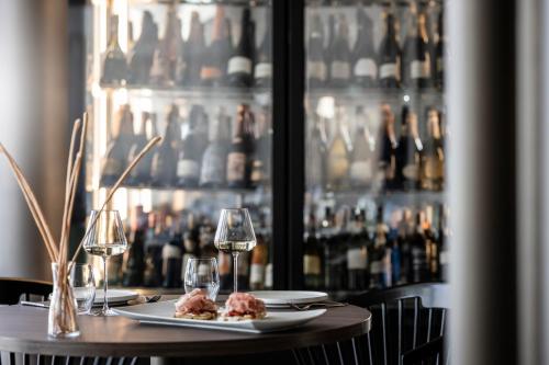 a table with two plates of food and wine glasses at Badia Hill in Badia