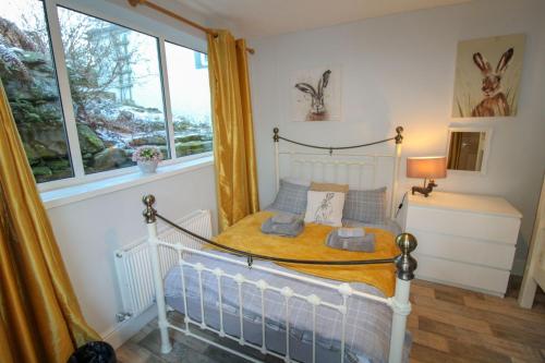 a bedroom with a bed and a window at Crag End Farm Retreat, Rogerscale, Nr Cockermouth in Lorton