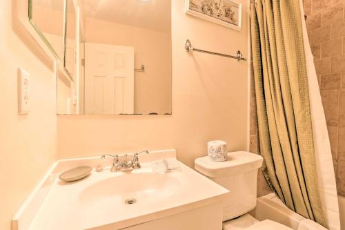 a bathroom with a sink and a toilet and a mirror at Walk to Beach Resort-Style Hilton Head Condo! in Hilton Head Island