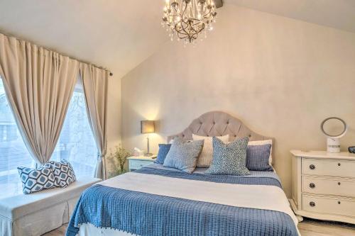 a bedroom with a bed and a chandelier at Horseshoe Bay Townhome with Patio and Outdoor Pool! in Horseshoe Bay