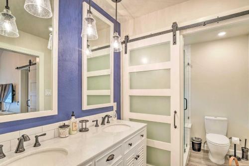 a bathroom with a sink and a toilet and a mirror at Horseshoe Bay Townhome with Patio and Outdoor Pool! in Horseshoe Bay