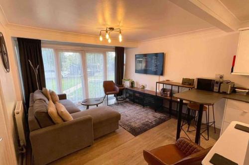 a living room with a couch and a table at Chalet 130 on Glan Gwna holiday park in Caernarfon