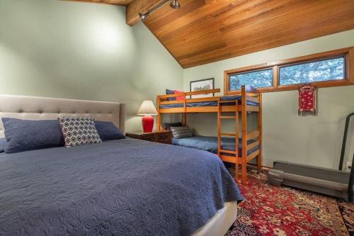 a bedroom with a bed and a bunk bed at Townhouse Art Gallery in Mammoth's Best Location in Mammoth Lakes