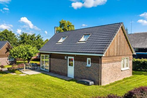 a small brick house with a roof on a yard at Holandský prázdninový dům Janův Důl in Januv Dul