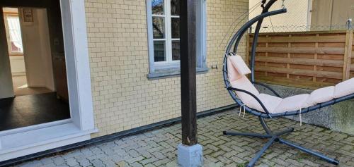 a chair sitting in front of a building at Unterkunft GLORIOS in Heiden