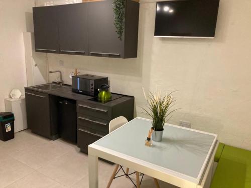 a kitchen with a white table and a counter top at Cosy 1 bedroom maisonette in the heart of Valletta in Valletta
