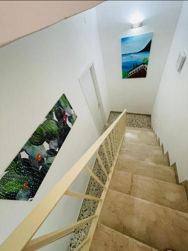a staircase in a house with a painting on the wall at Bella Tao in Taormina