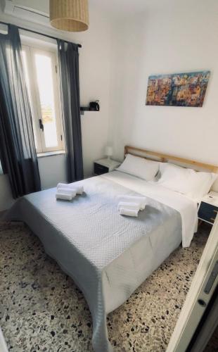 a bedroom with a large bed with two towels on it at Bella Tao in Taormina