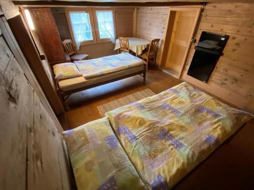 an overhead view of a room with a bed and a kitchen at Ferienhaus Schönenmatte in Zweisimmen