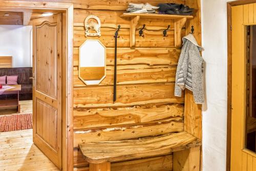 a log cabin bathroom with a wooden wall at Chalupa pod lipou in Oščadnica