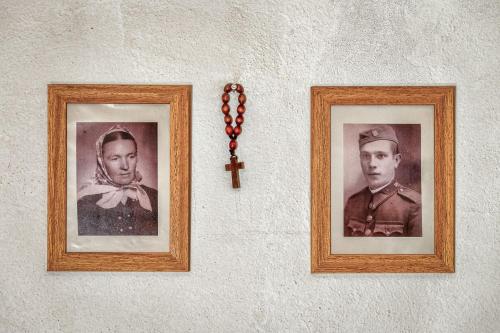 two pictures of a man and a cross on a wall at Chalupa pod lipou in Oščadnica