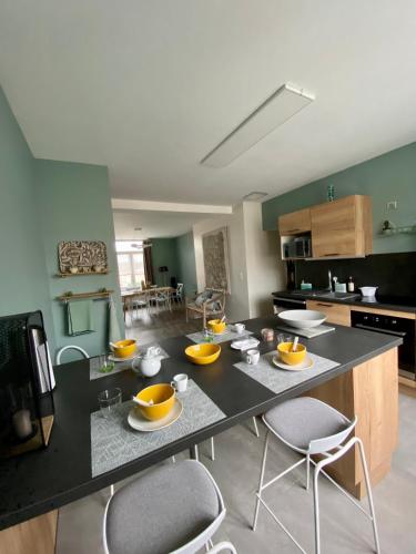 a kitchen with a table with orange bowls on it at APPARTEMENT KENNEDY in Boulogne-sur-Mer