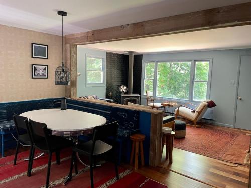 a living room with a table and some chairs at The perfect getaway cabin in Washington