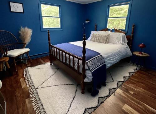 um quarto com uma cama com uma parede azul em The perfect getaway cabin em Washington