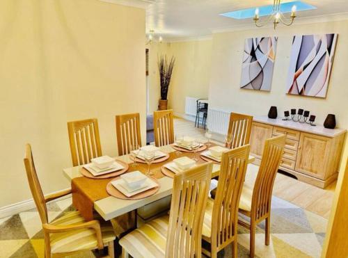 a dining room with a wooden table and chairs at Spacious & modern 3 bedroom house in Peterlee in Wingate