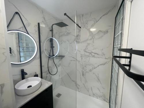 Chalifert的住宿－Appartement Cosy - Disney Paris，一间带水槽和玻璃淋浴的浴室
