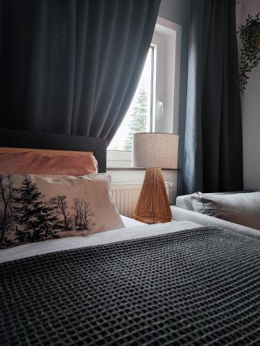 a bedroom with a bed with a window at Elias im Landhausstil in Bayreuth