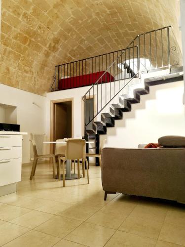 a living room with a staircase and a table and chairs at La casa del nonno in Matera
