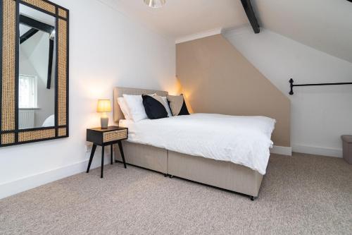 a bedroom with a bed and a large mirror at south view in Bournemouth