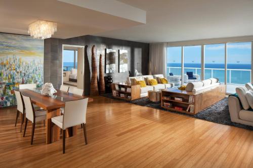 a living room with a table and chairs and a couch at W Fort Lauderdale in Fort Lauderdale