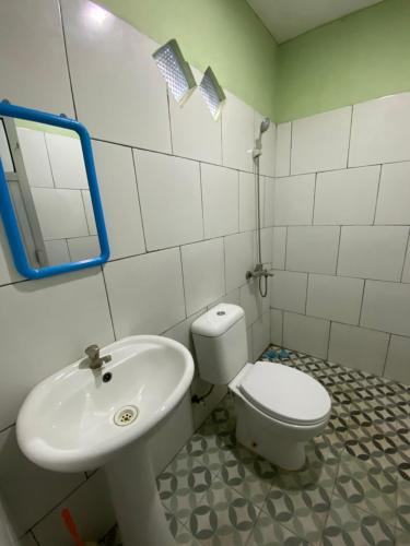 uma casa de banho com um WC e um lavatório em Karina Guest House Syariah em Tangkil