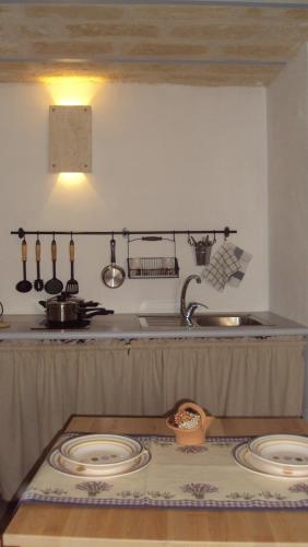 a kitchen with two plates on a counter and a sink at Bed & Breakfast Casa Lopez in Barletta