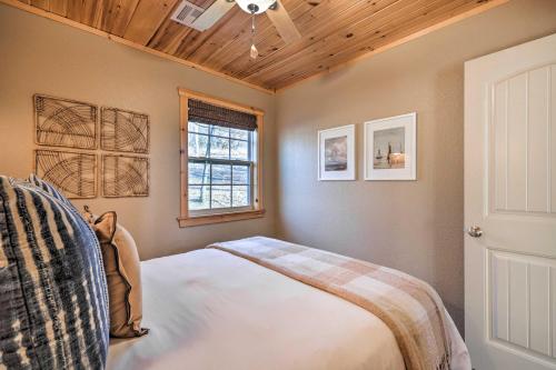 a bedroom with a bed and a window at Pet-Friendly Grand Lake House with Dock and Kayaks! in Eucha