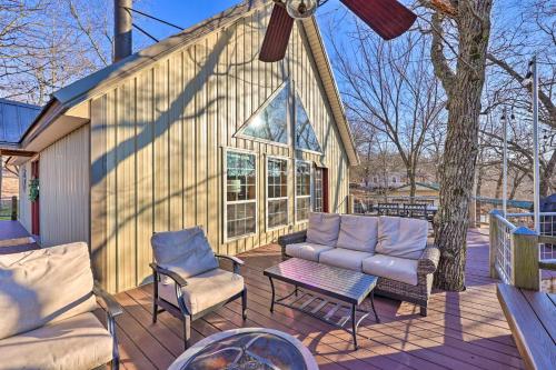 a patio with a couch and chairs on a deck at Pet-Friendly Grand Lake House with Dock and Kayaks! in Eucha