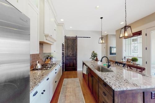 a kitchen with white cabinets and granite counter tops at Barber Valley Beauty in Boise