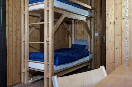 a couple of bunk beds in a wooden room at La Stalla - Mid-Century Rustico in Calpiogna