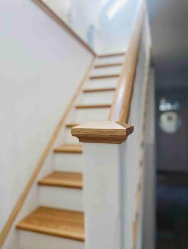a set of stairs in a house with wooden steps at Teach Dunmore in the heart of Donegal Gaeltacht. in Falcarragh