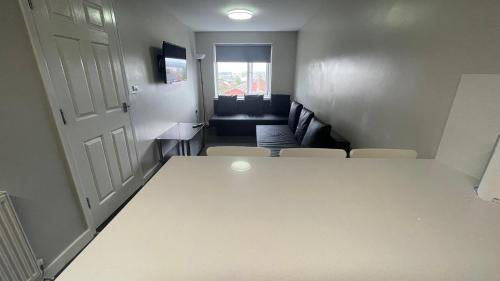 a living room with a white table and a couch at Hosted By Ryan - 2 Bedroom Apartment in Liverpool