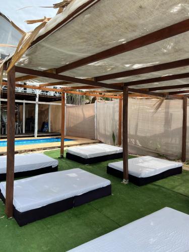 a tent with two beds in a room with a pool at MIRADOR DE BARU in Cartagena de Indias