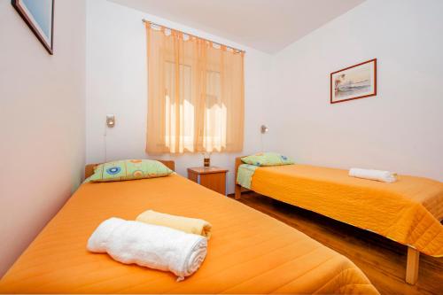 two beds sitting next to each other in a room at Apartments Bella B in Rovinj