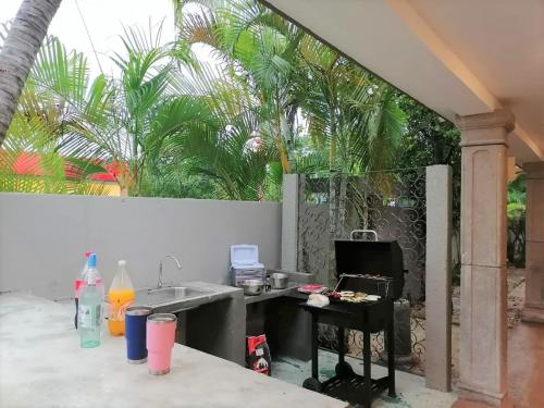 a kitchen with a sink and a table and trees at Casa Rafaelita in Mérida