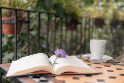 an open book and a cup of coffee on a table at Tu cabaña Cuernavaca - hospedaje by Arcadia in Cuernavaca