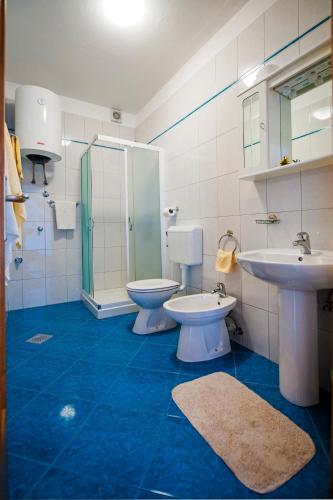 a bathroom with a toilet and a sink and a shower at Apartments Bella B in Rovinj